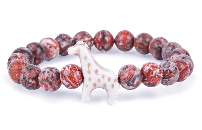 Elasticated bracelet featuring marble patterned red and brown balls and a white giraffe pendant with beige spots